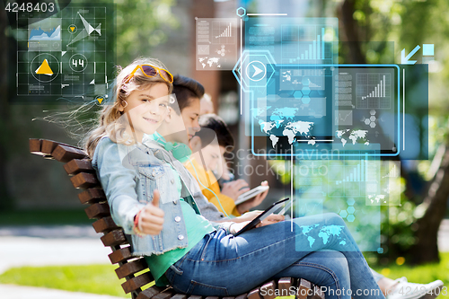 Image of happy teenage girl with tablet pc outdoors