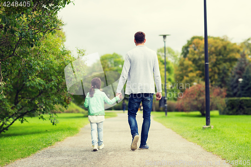 Image of happy family walking in summer park