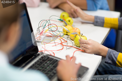 Image of kids, invention kit and laptop at robotics school