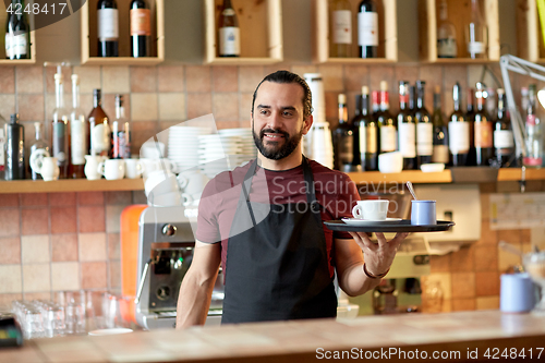 Image of happy man or waiter with coffee and sugar at bar