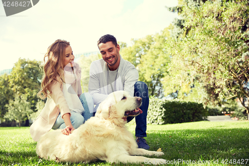 Image of happy couple with labrador dog walking in city