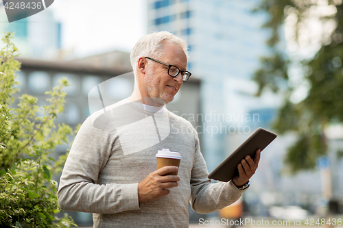 Image of senior man with tablet pc and coffee in city