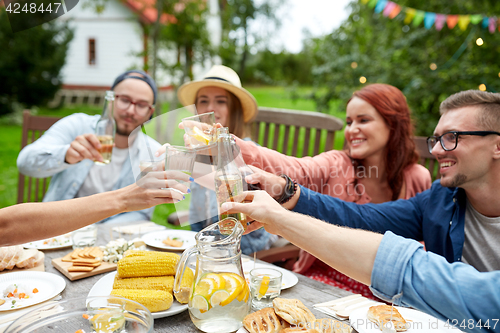 Image of happy friends with drinks at summer garden party