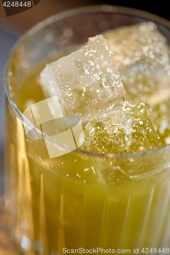 Image of close up of glass with cocktail at bar