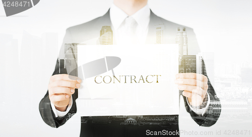 Image of close up of businessman holding contract paper