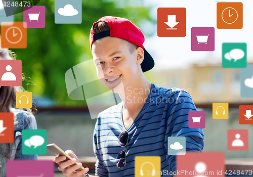 Image of happy teenage boy with smartphone outdoors