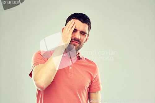 Image of unhappy man suffering from head ache