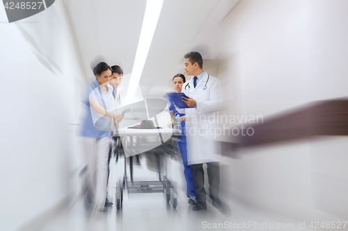 Image of medics and patient on hospital gurney at emergency