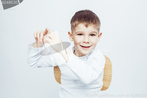 Image of little cute adorable boy posing gesturing cheerful on white background, lifestyle people concept closeup