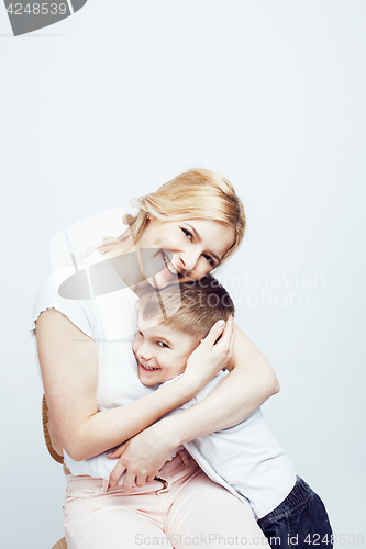 Image of young modern blond curly mother with cute son together happy smiling family posing cheerful on white background, lifestyle people concept, sister and brother friends