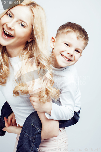 Image of young modern blond curly mother with cute son together happy smiling family posing cheerful on white background, lifestyle people concept, sister and brother friends