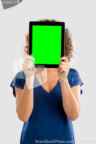 Image of Happy woman holding tablet