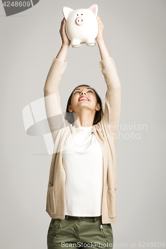 Image of Woman holding piggybank