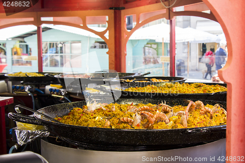 Image of Seafood paella sold at street market stand