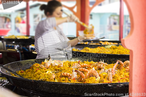 Image of Seafood paella sold at street market stand