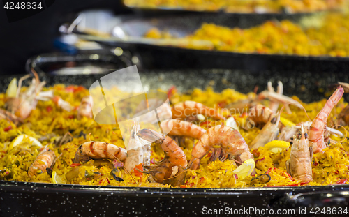 Image of Seafood paella sold at street market stand