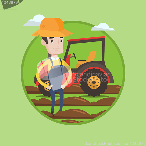 Image of Farmer standing with tractor on background.