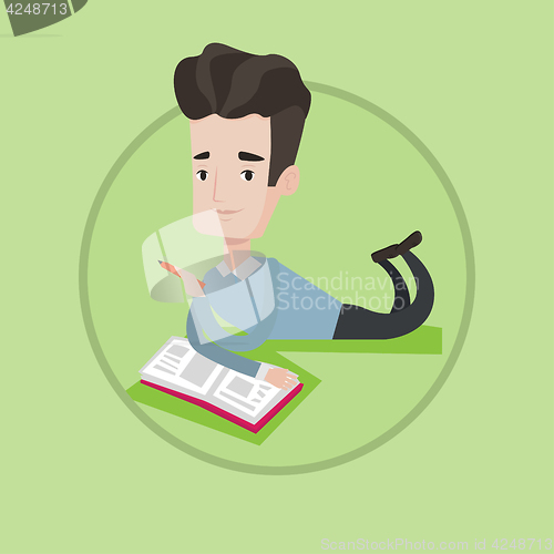 Image of Student laying on the floor and reading book.