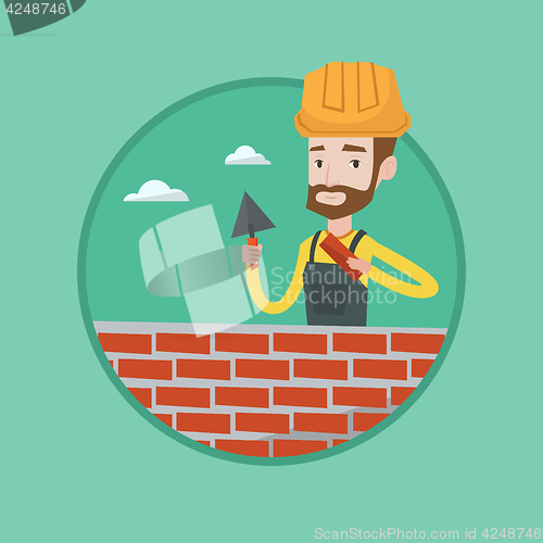 Image of Bricklayer working with spatula and brick.