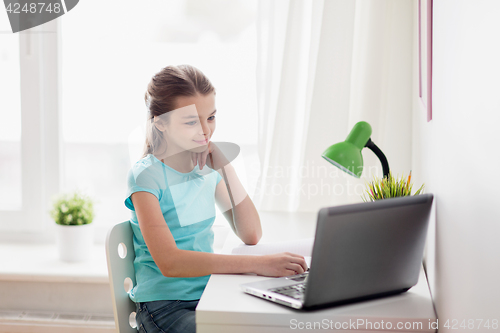 Image of girl with laptop at home