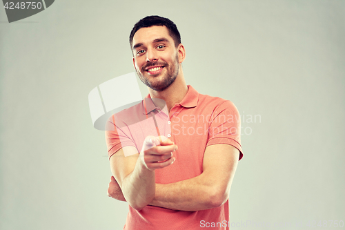 Image of man pointing finger to you over gray background