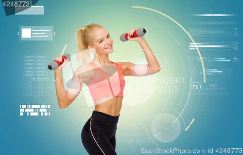 Image of happy young sporty woman exercising with dumbbells