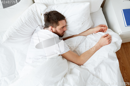 Image of man sleeping in bed at home bedroom