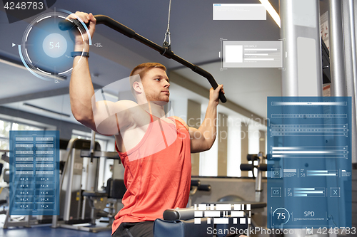 Image of man flexing muscles on cable machine gym