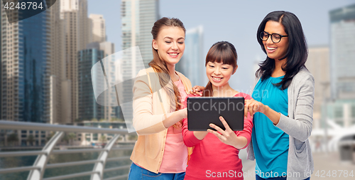 Image of international happy women with tablet pc in city
