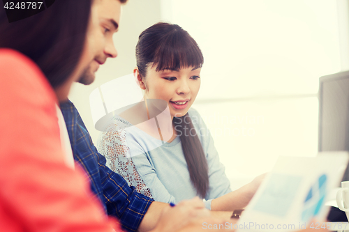 Image of happy creative team or students working at office