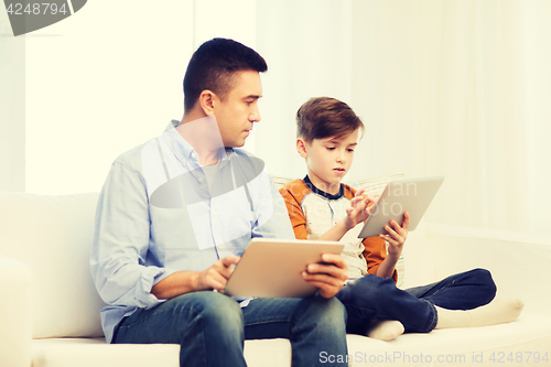 Image of father and son with tablet pc at home