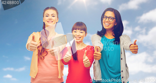 Image of international happy women showing thumbs up