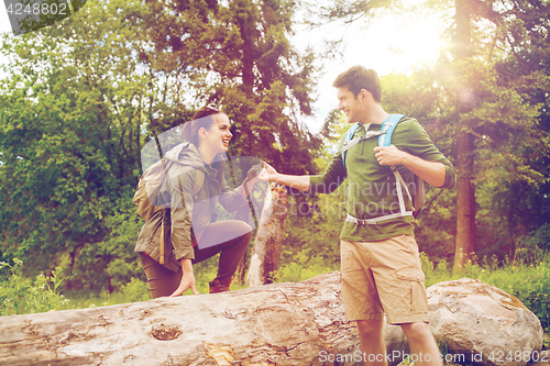 Image of smiling couple with backpacks hiking