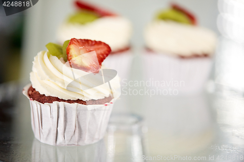 Image of cupcake with cream and strawberry at sweet shop