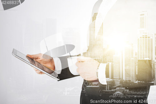 Image of close up of businessman with tablet pc and coffee