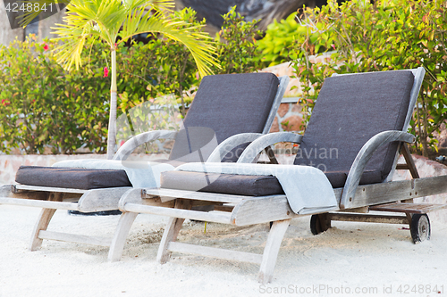 Image of sunbeds on exotic resort beach