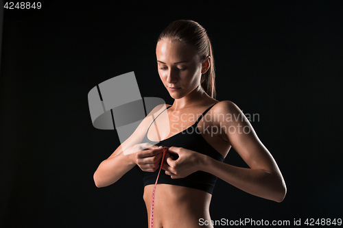 Image of The fit woman measuring perfect shape of beautiful body. Healthy lifestyles concept