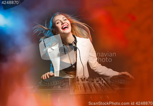 Image of Beautiful blonde DJ girl on decks - the party,