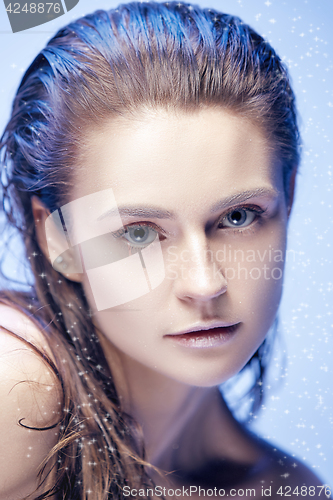 Image of Beautiful woman face portrait close up on blue