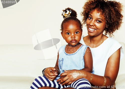 Image of adorable sweet young afro-american mother with cute little daughter, hanging at home, having fun playing smiling, lifestyle people concept, queen girl