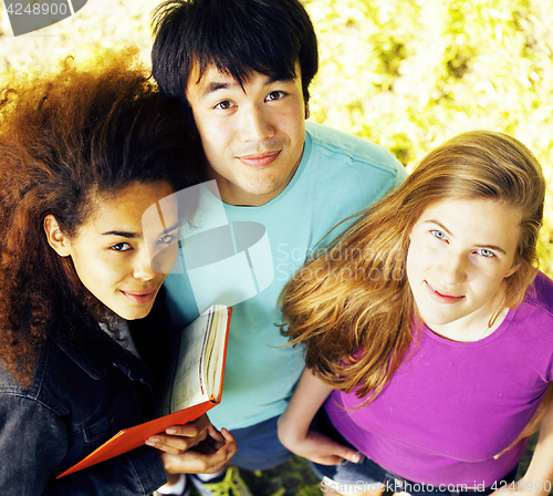 Image of cute group of teenages at the building of university with books huggings, diversity nations