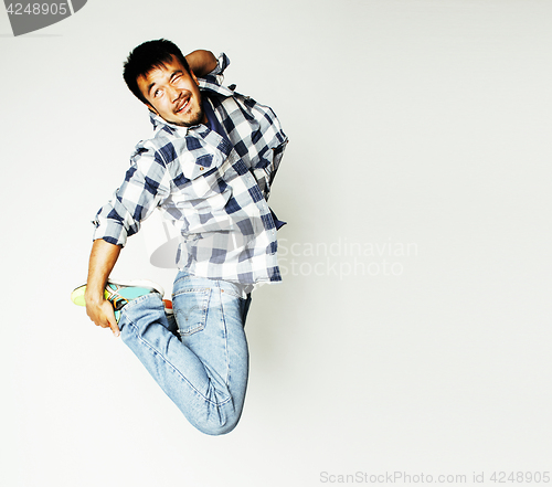 Image of young pretty asian man jumping cheerful against white background