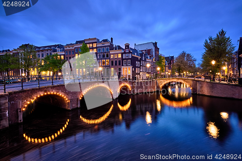 Image of Amterdam canal, bridge and medieval houses in the evening