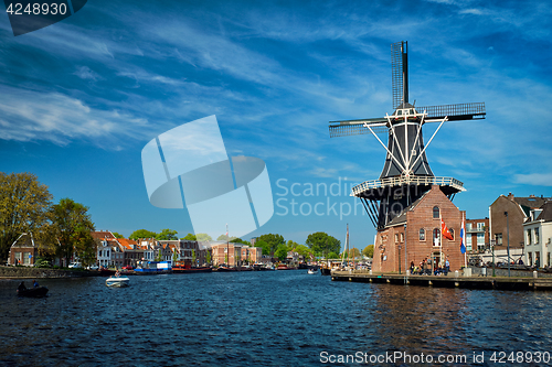 Image of Harlem landmark  windmill De Adriaan on Spaarne river. Harlem,  