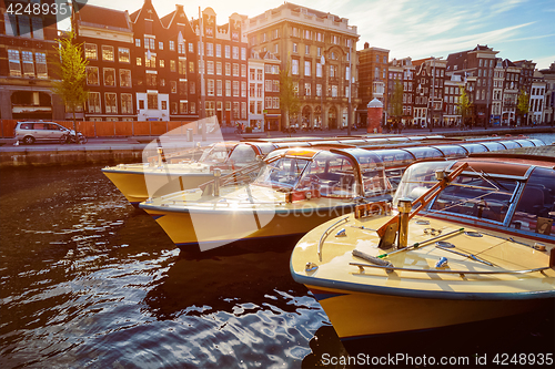 Image of Amsterdam tourist boats in canal