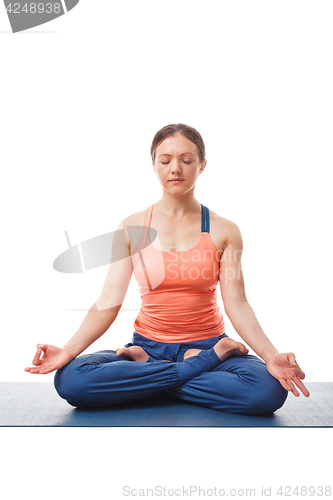 Image of Woman meditating in yoga asana Padmasana Lotus pose