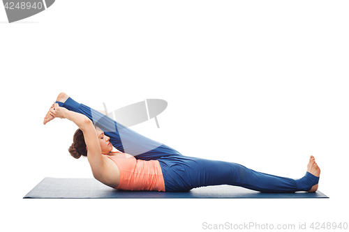 Image of Woman doing Yoga asana Supta padangusthasana isolated