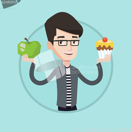 Image of Man choosing between apple and cupcake.