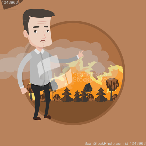 Image of Man standing on background of forest fire.