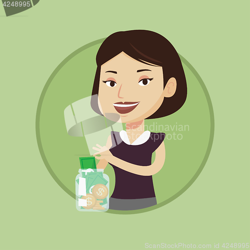 Image of Woman putting dollar into money box.